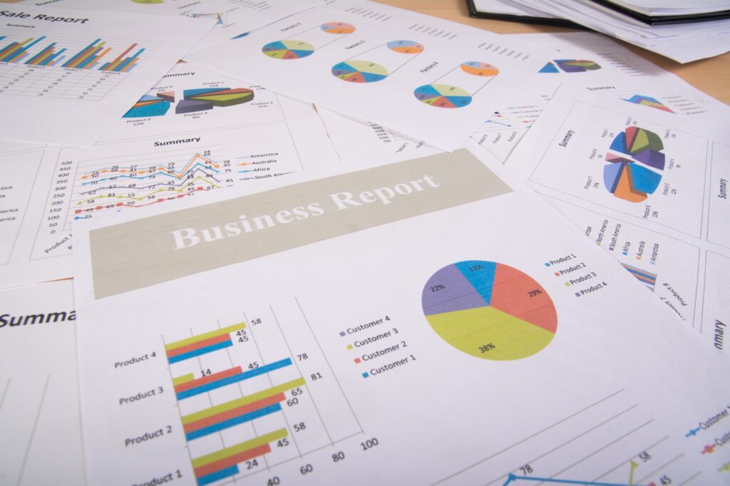 Business report documents featuring graphs, charts, and data summaries related to sales and customer analysis, emphasizing PPC advertising insights for maximizing ROI.