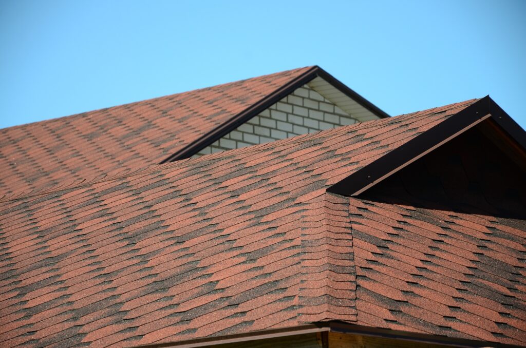 Roof covered with brown bituminous shingles, showcasing quality roofing suitable for roofing company websites.
